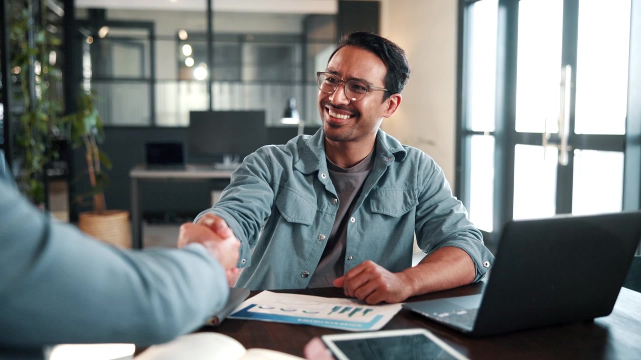 Two Business Professionals Shaking Hands in Modern Office