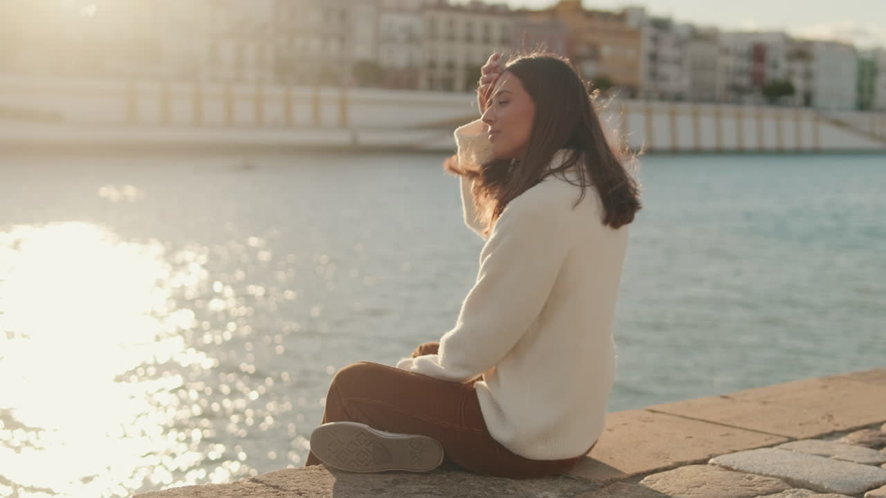 Woman by the River in Seville at Sunset