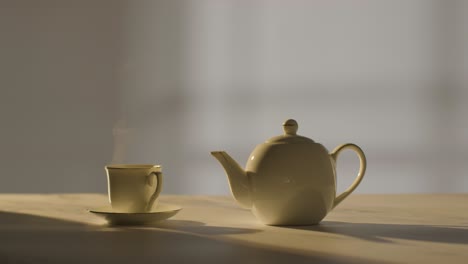 studio shot of making traditional british cup of tea using teapot 5
