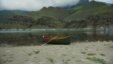 scenic mountain lake with canoe