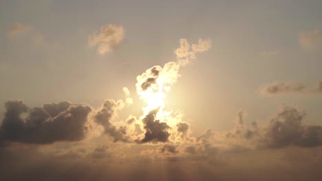 timelapse video towards the sun in a cloudy sky at sunset