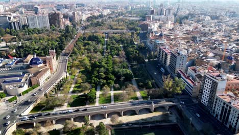 steady slow drone shot of the huge central park that runs 9kms through valencia that located in spain