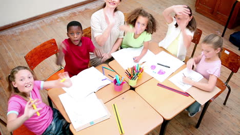 Teacher-and-pupils-waving-their-hands