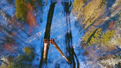 Electricity-installation.-High-voltage-tower-in-winter-forest.-Energy-industry