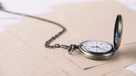 pocket watch on lined paper