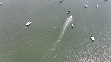 an aerial view of the northport marina on long island, ny with several anchored boats on a sunny day