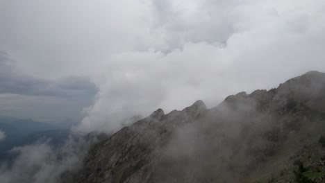 misty mountain cliffs enveloped by dense clouds in a serene natural setting