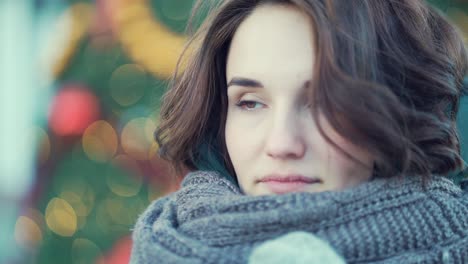 woman in winter clothes near christmas decorations