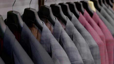 collection of fashionable men's suits displayed elegantly at a downtown boutique