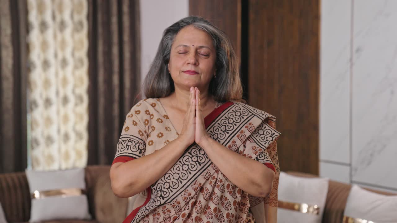 Religious Indian woman praying to god