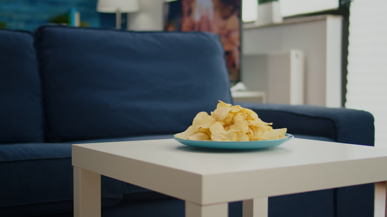 Chips snack sitting on coffe table in front of cozy sofa