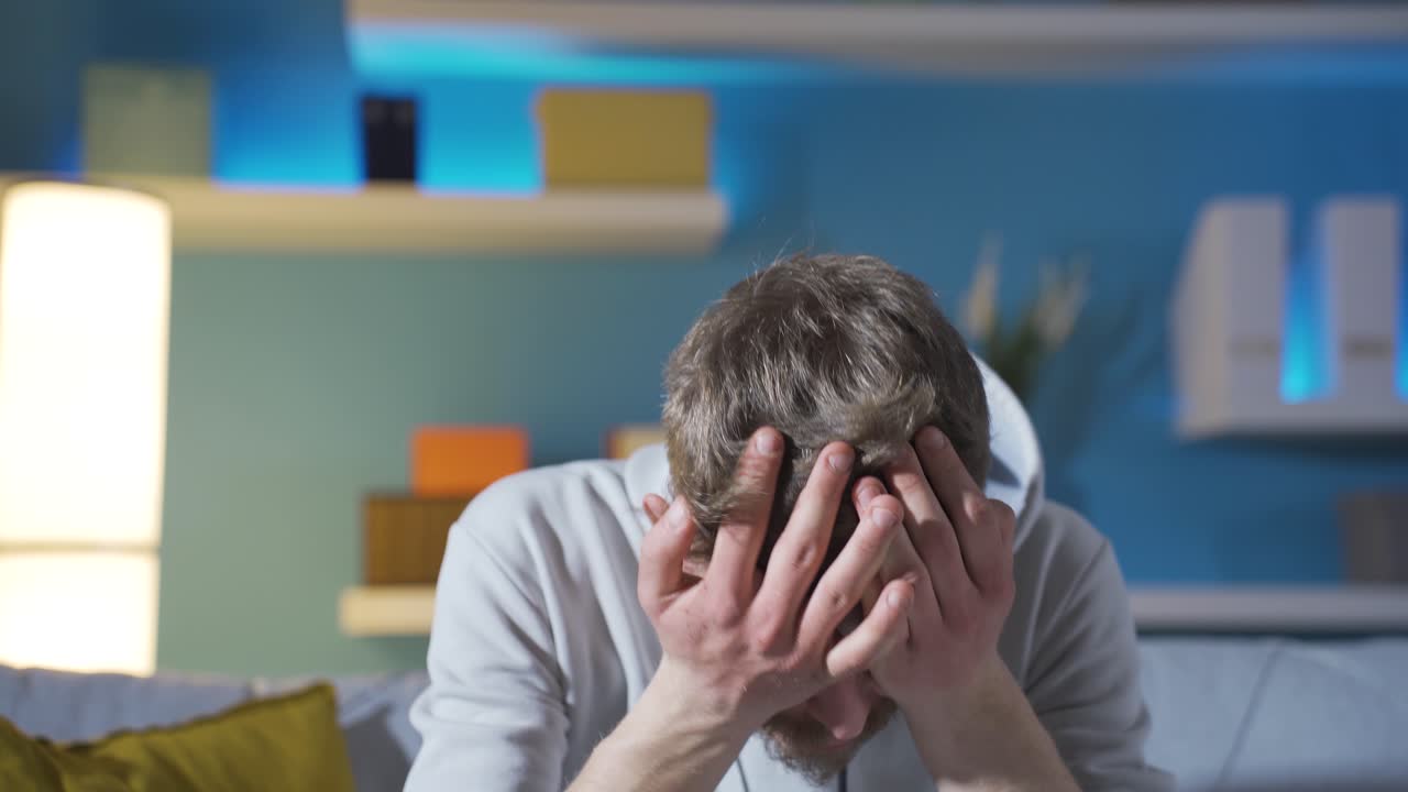 Frustrated and worried young man crying.