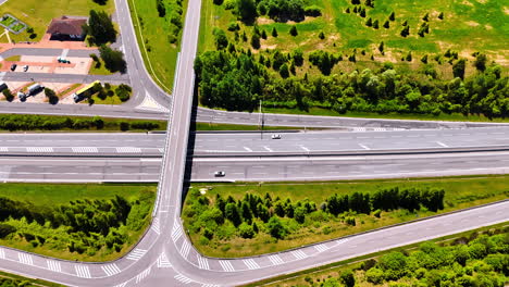highways and freeways surrounded by green lawns and trees. road conjunction in slovakia on sunny day. top view