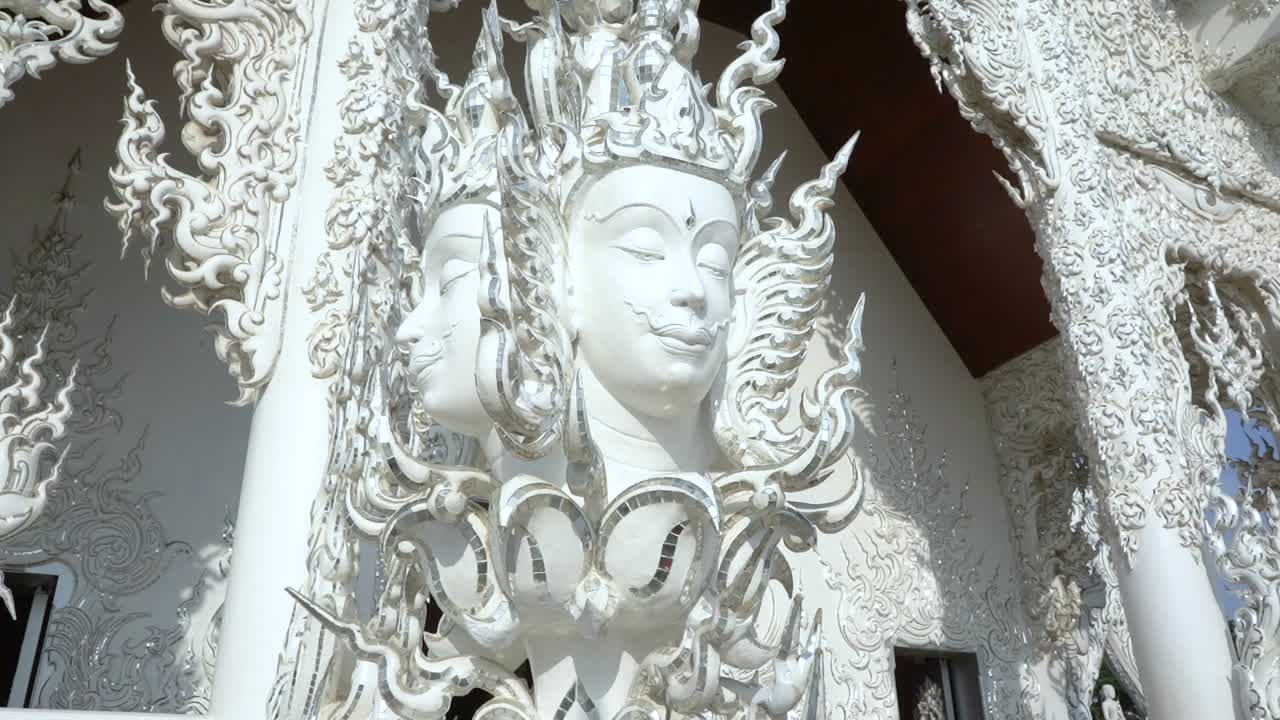 Amazing multi faced statue at the White Temple in Chiang Rai, Thailand.