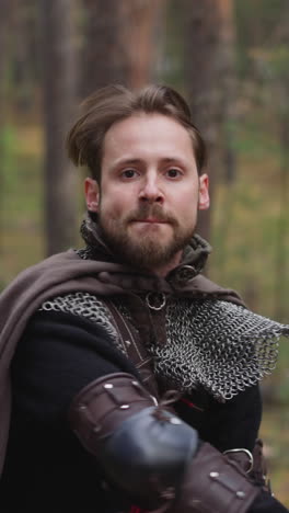 man in armor wields sword in forest, fencing, jousting