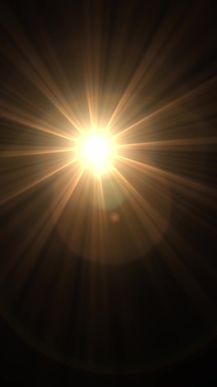 Bagliore caldo e dorato dell'obiettivo che simula un sole splendente, che si muove da sinistra a destra su uno sfondo nero, in loop continuo.