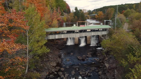 Drone-shot-flying-over-dam-on-river-for-hydropower-energy-generation