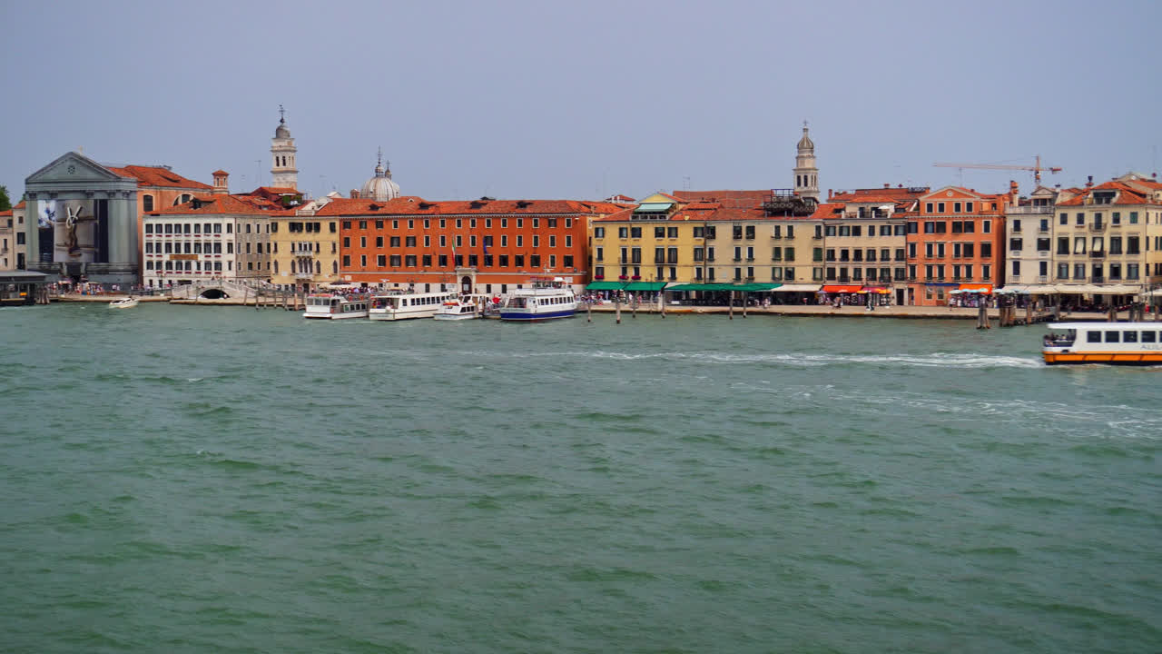 Ferry Boat And Speedboat Traveling Across The Venetian Lagoon In Venice, Italy. - wide