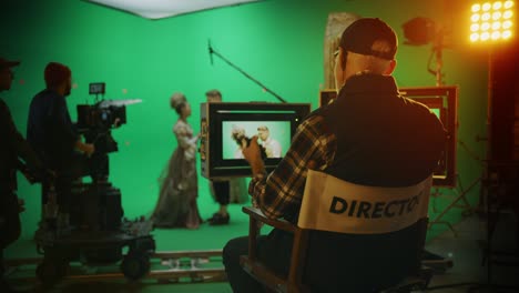 director shooting period film green screen cgi scene with actors wearing renaissance costumes. big film studio professional crew shooting big budget movie. back view following shot