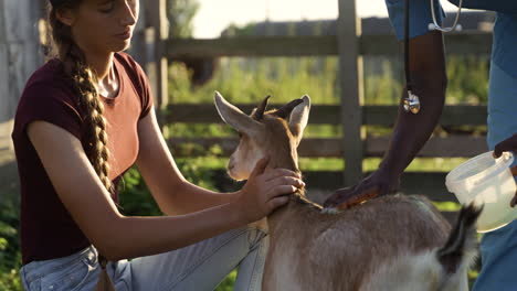 farmer holding goat outdoors