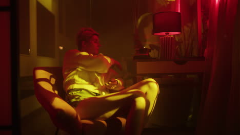 woman reading in a neon lit room