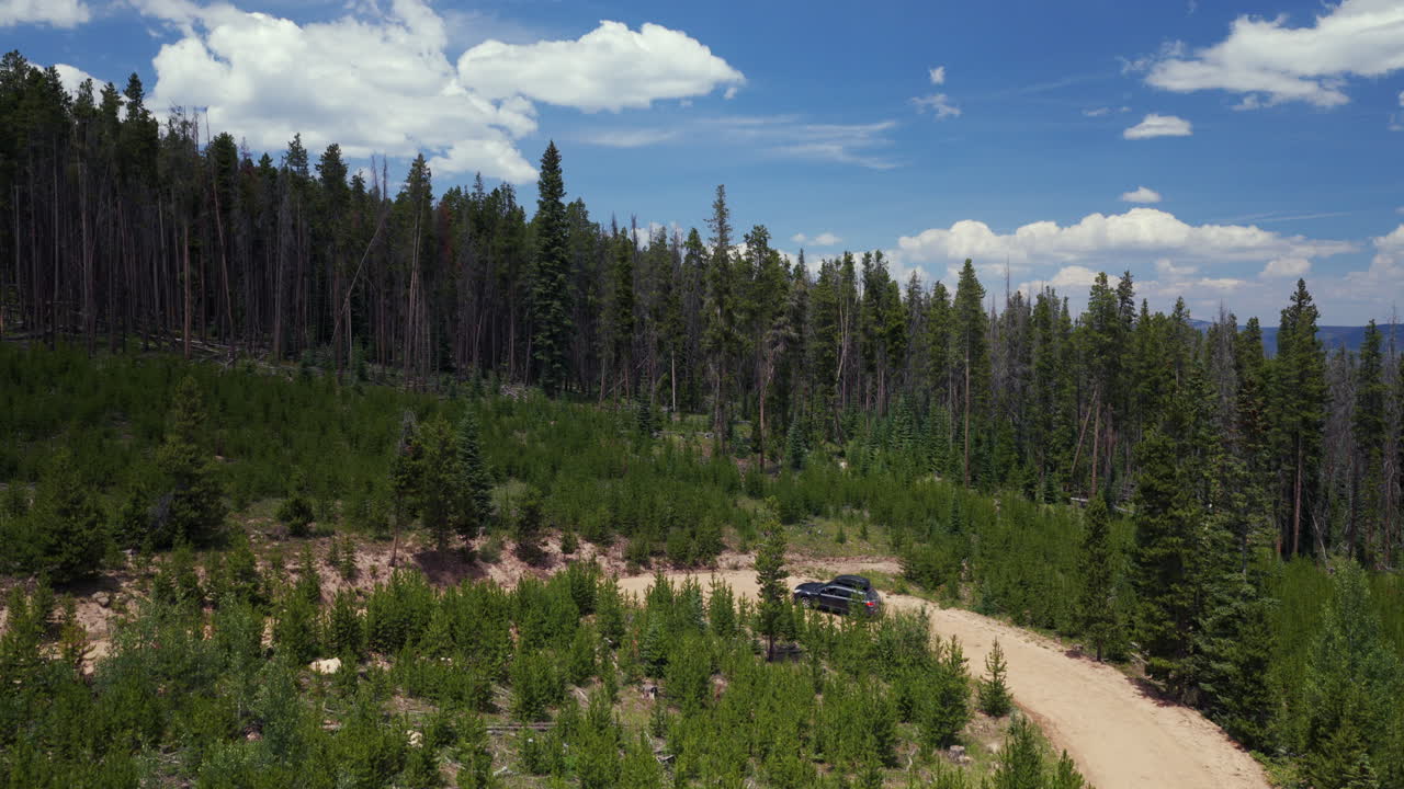 Mount of the Holy Cross AWD car driving dirt road car aerial drone Rocky Mountains Colorado Notch Mountain creek Falls Creek Trail Half moon pass Vail Minturn summer morning blue sky forward follow