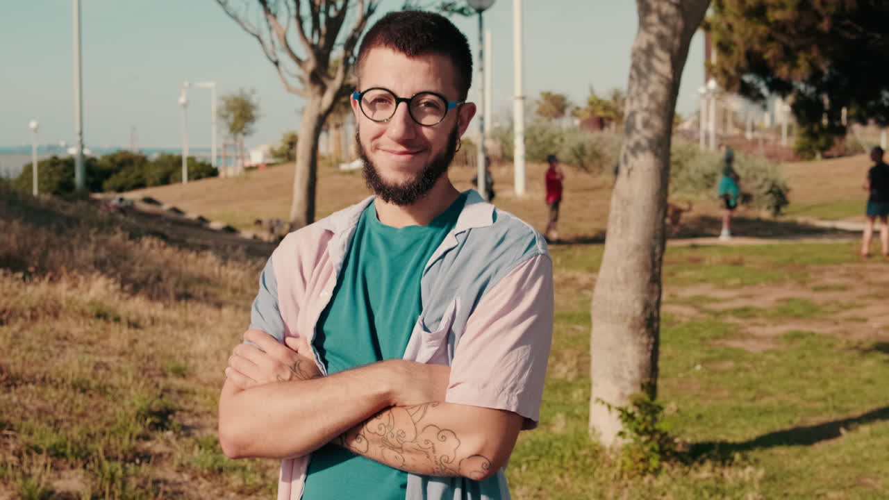 Man Smiling at Camera With Friends in Park