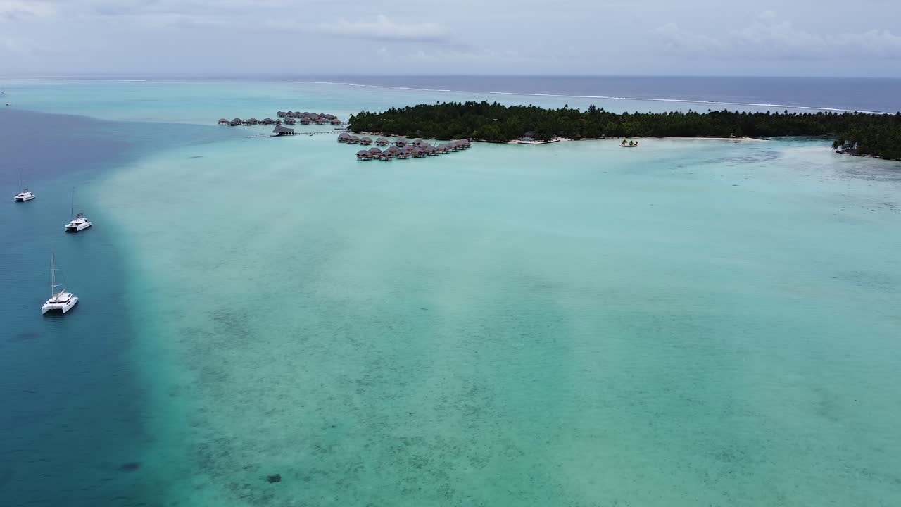 Atoll flyover: Over water villa suites in Polynesian style, Taha'a