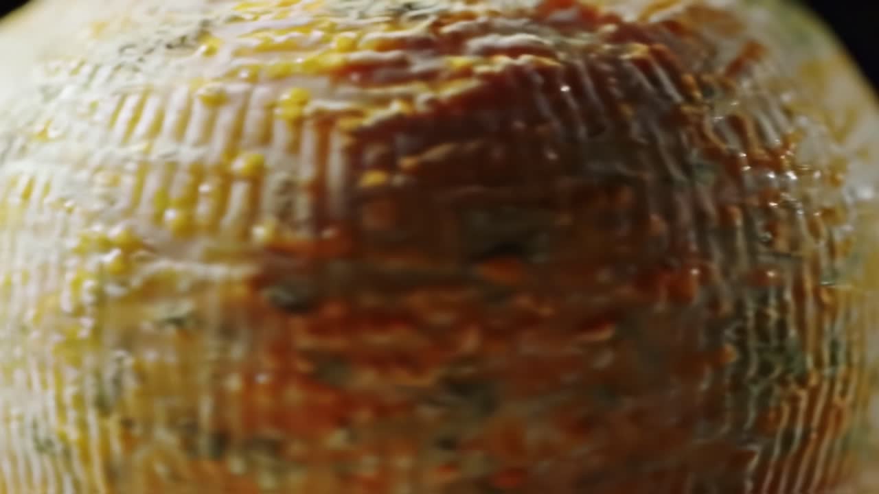 Close-up Shots of a Handcrafted Cheese Sphere: Exploring Texture, Color, and Artisan Craftsmanship in Dairy Products