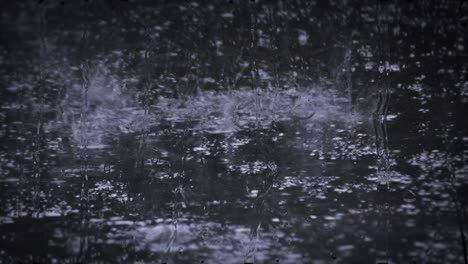 heavy rain shower downpour cloudburst rainfall behind the glass.