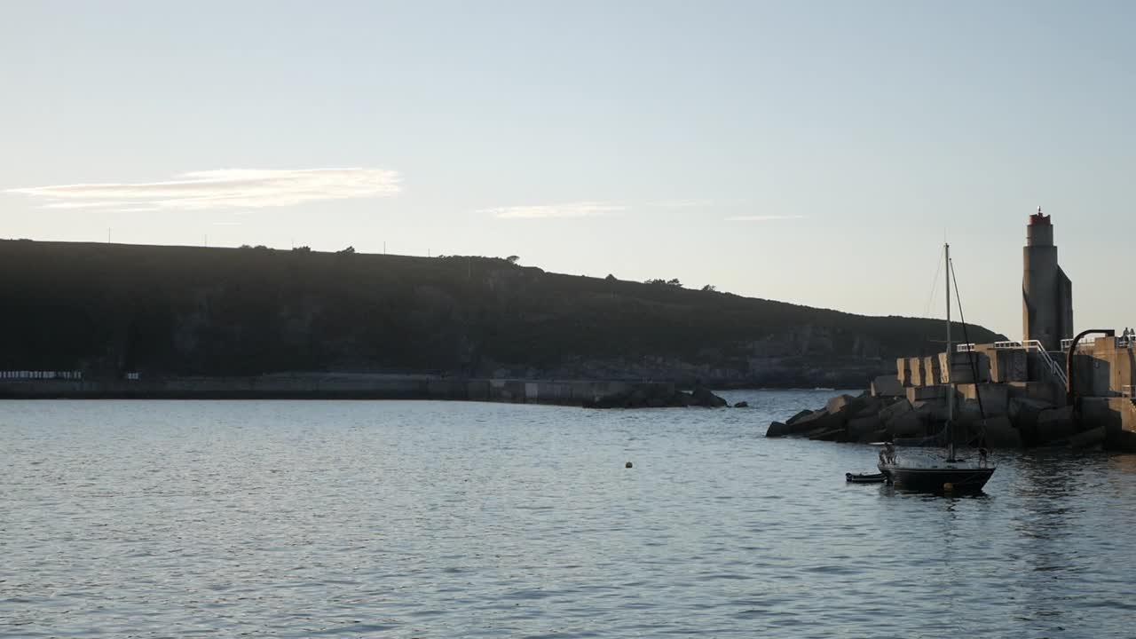 Port at sunset in Cudillero, Asturias with calm sea and dramatic cliff backdrop