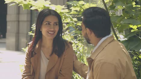 muslim couple on date sitting and talking together on city street 1