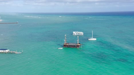 Tourist-ancient-wooden-boat-on-tropical-sea-waters-of-Los-Corales-beach-in-Dominican-Republic