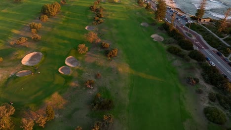 aerial view of golfers at cottesloe beach golf course, perth, western australia