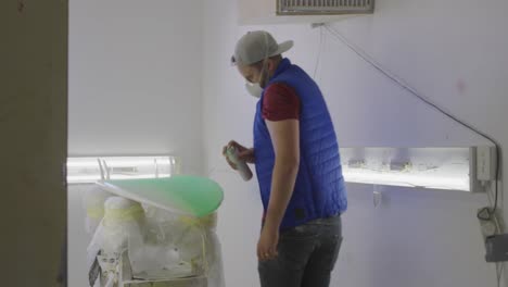 male surfboard maker in his workshop