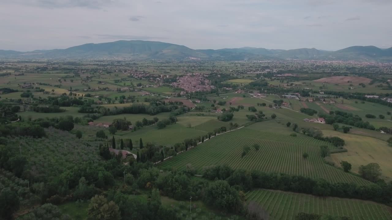 Aerial Drone shot Flying Towards Medieval Town Over Italian Countryside in Umbria, Italy