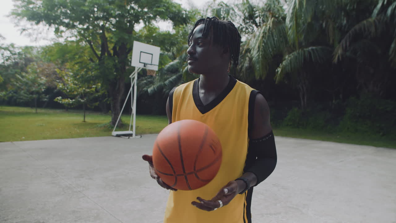 Basketball Player Waiting for Friend and Smiling at Camera