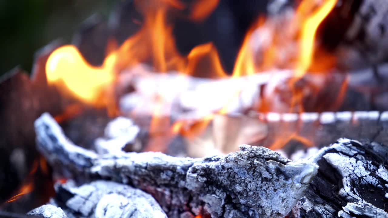 Burning firewood in fire place. Close up of outdoor fire burning