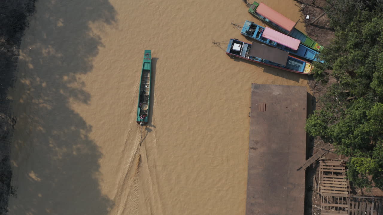 Bird's eye view of a boat on a muddy river Tonle Sap Cambodia