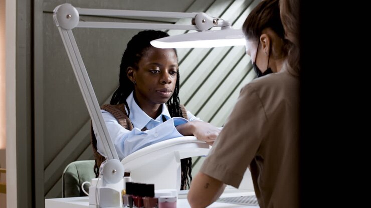 Woman getting a manicure at a nail salon