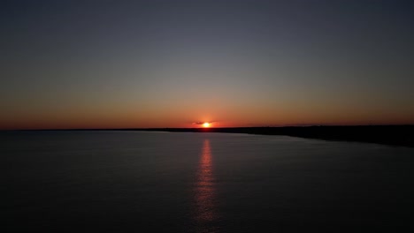 side movement shot of the sunset in a beach in port stanley, ontario, canada. side movement gives the effect of water moving faster than it actually is