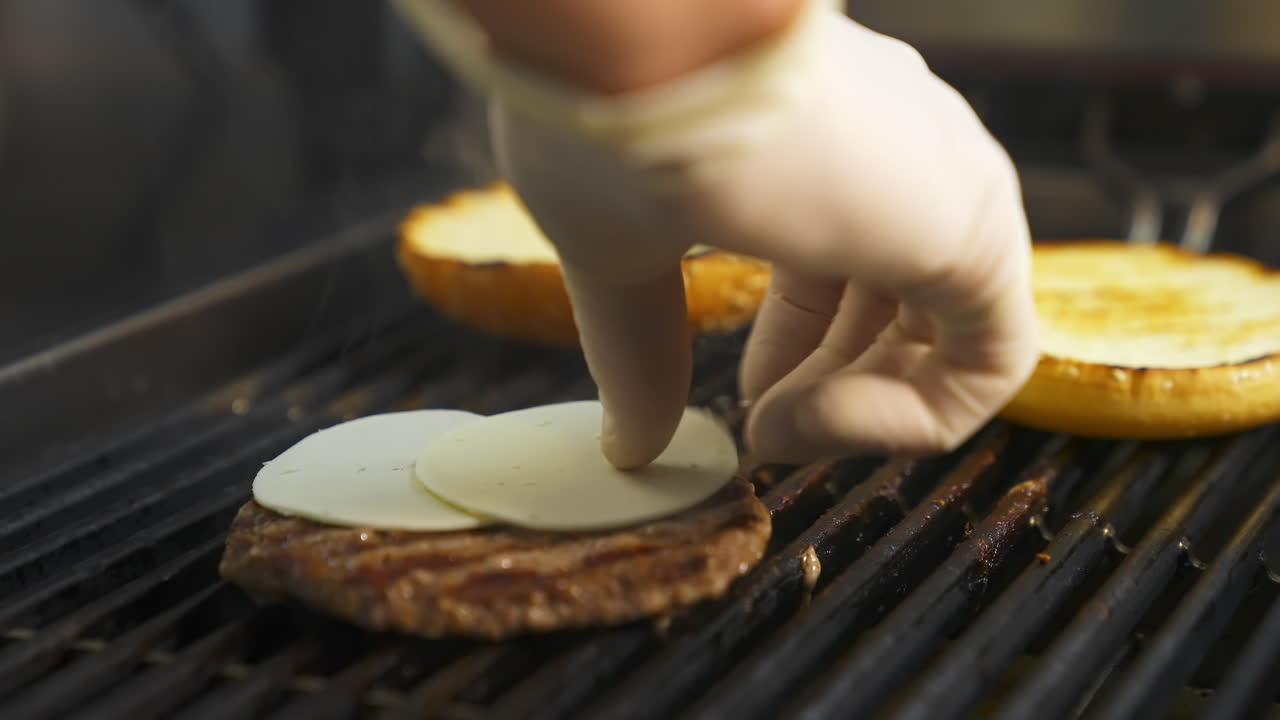 Grilled meat cutlets on metal grill. Cooking meat and patties for hamburger. Beef or pork cutlet grilling on grid.