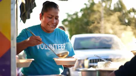 a dedicated volunteer offers meals at a community outreach event, showcasing generosity and commitment to helping others in need