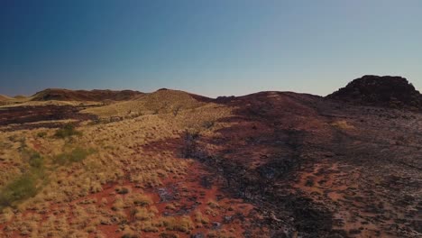 aerial drone elevating over vast australian desert after bushfire