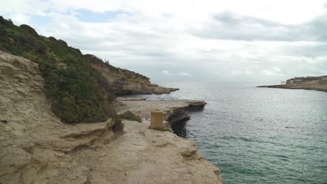 Walking-on-Il-Kalanka-Beach-in-Malta-with-Splashing-Turquoise-Colour-Water-in-Bay