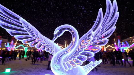 ice swan sculpture at night