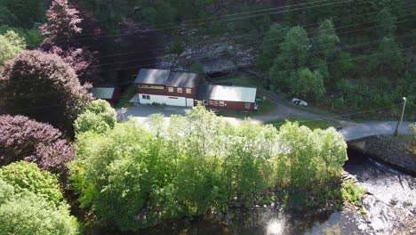 dalekvam salmon hatchery - successfull hatchery of wild salmon smolt locasted in western norway - aerial view of hatchery and river coming from powerplant tunnel