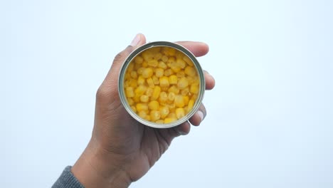 canned corn in hand