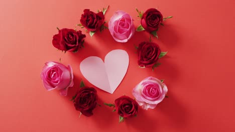 Red-and-pink-roses-with-heart-on-red-background-at-valentine's-day