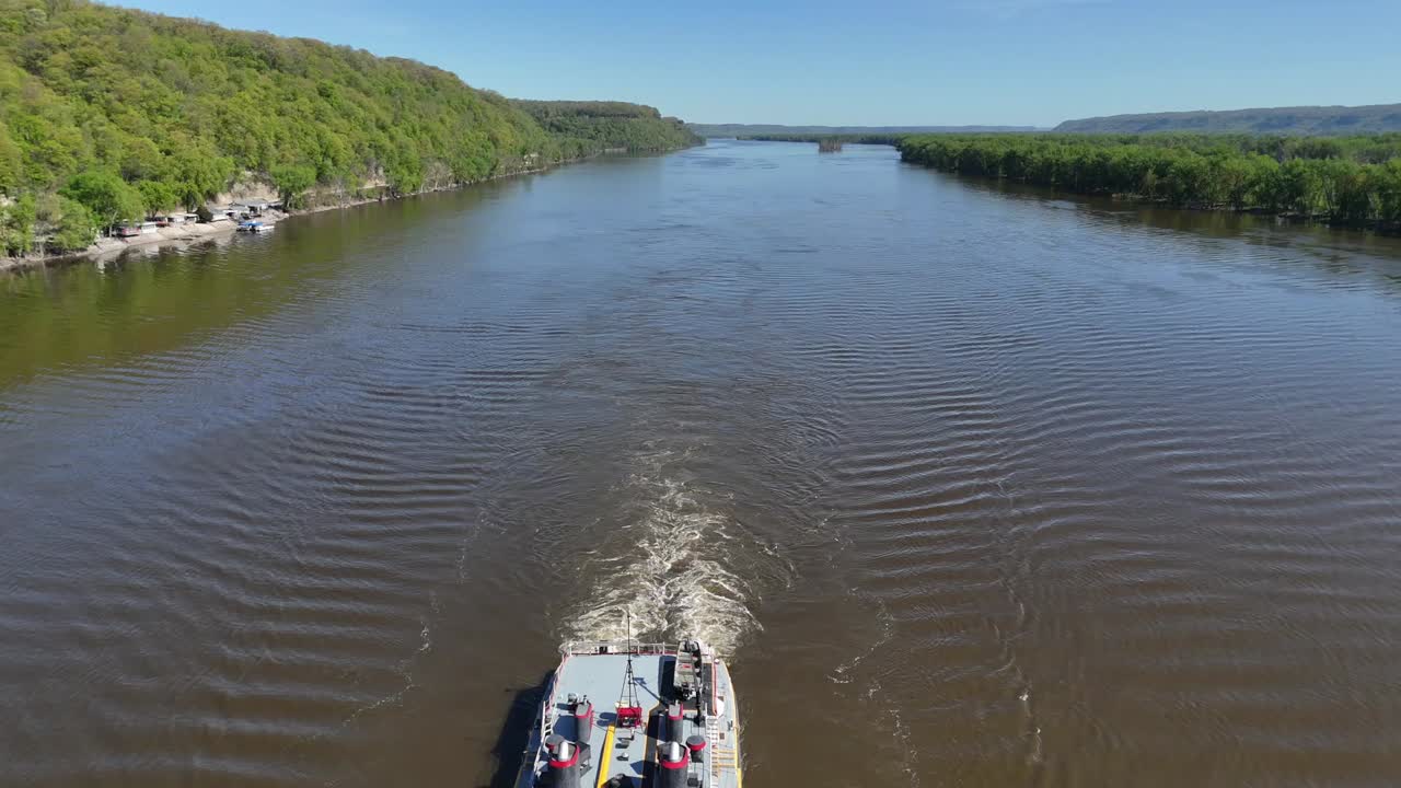Located along the Mississippi River between Minnesota and Wisconsin's Driftless area, a towboat move a set of barges south.